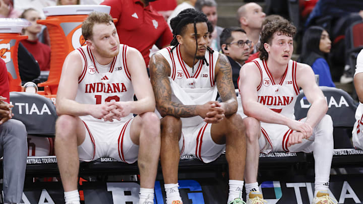 Indiana forward Tucker Devries (12), guard Lamar Wilkerson (3) and guard Conor Enright (5) sit on the bench during the Big Ten tournament.