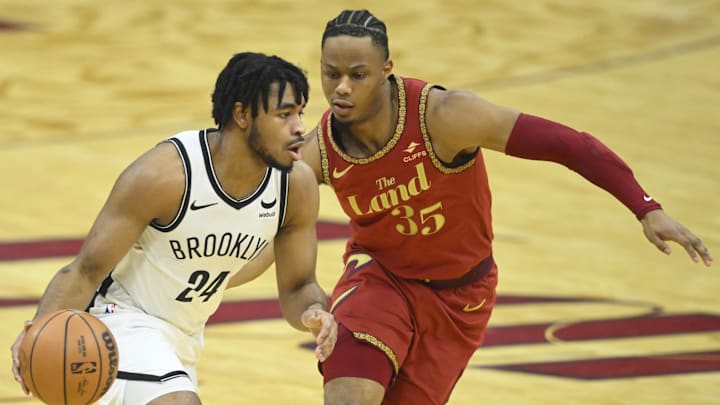 Mar 10, 2024; Cleveland, Ohio, USA; Brooklyn Nets guard Cam Thomas (24) dribbles beside Cleveland Cavaliers forward Isaac Okoro (35) in the first quarter at Rocket Mortgage FieldHouse. Mandatory Credit: David Richard-Imagn Images