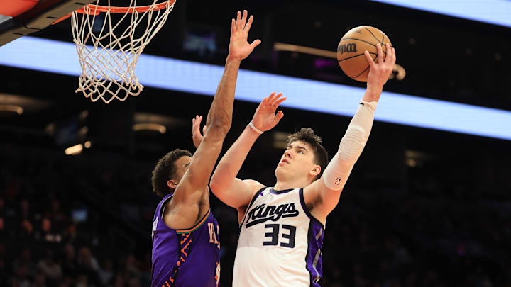 Mar 14, 2025; Phoenix, Arizona, USA; Sacramento Kings forward Jake LaRavia (33) shoots the ball against the Phoenix Suns during the second half at Footprint Center. Mandatory Credit: Mark J. Rebilas-Imagn Images