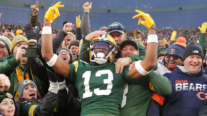 Green Bay Packers wide receiver Dontayvion Wicks (13) celebrates after catching a touchdown pass against Chicago Bears cornerback Terell Smith (32) during their football game Sunday, January 7, 2024, at Lambeau Field in Green Bay, Wis.