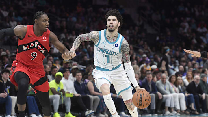 Jan 7, 2026; Charlotte, North Carolina, USA; Charlotte Hornets guard LaMelo Ball (1) drives in past Toronto Raptors guard RJ Barrett (9) during the first half at the Spectrum Center. Mandatory Credit: Sam Sharpe-Imagn Images Jan 7, 2026; Charlotte, North Carolina, USA; Charlotte Hornets guard LaMelo Ball (1) drives in past Toronto Raptors guard RJ Barrett (9) during the first half at the Spectrum Center. Mandatory Credit: Sam Sharpe-Imagn Images