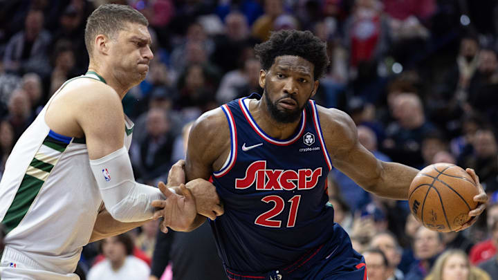Mar 29, 2022; Philadelphia, Pennsylvania, USA; Philadelphia 76ers center Joel Embiid (21) drives with the ball against Milwaukee Bucks center Brook Lopez (11) during the second quarter at Wells Fargo Center. Mandatory Credit: Bill Streicher-Imagn Images Mar 29, 2022; Philadelphia, Pennsylvania, USA; Philadelphia 76ers center Joel Embiid (21) drives with the ball against Milwaukee Bucks center Brook Lopez (11) during the second quarter at Wells Fargo Center. Mandatory Credit: Bill Streicher-Imagn Images