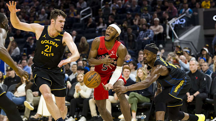 Mar 20, 2025; San Francisco, California, USA; Toronto Raptors guard Immanuel Quickley (5) passes past Golden State Warriors center Quinten Post (21) and forward Jimmy Butler III (10) during the fourth quarter at Chase Center. Mandatory Credit: John Hefti-Imagn Images