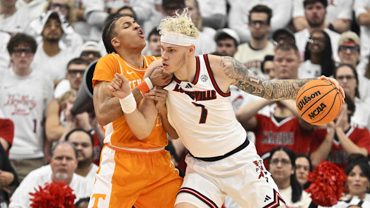 Nov 9, 2024; Louisville, Kentucky, USA;  Louisville Cardinals forward Kasean Pryor (7) controls the ball as Tennessee Volunteers guard Cameron Carr (43) defends during the first half at KFC Yum! Center. Tennessee defeated Louisville 77-55. Mandatory Credit: Jamie Rhodes-Imagn Images