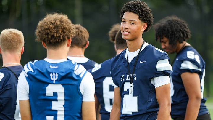 Chris Vargas of St. John's Prep chats with Leominster's Osiris Lopez during HS football media day at Needham High School on Wednesday, August 13, 2025.