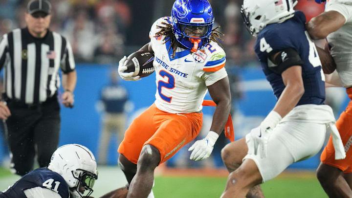 Boise State Broncos running back Ashton Jeanty (2) runs past Penn State Nittany Lions linebacker Kobe King (41) during their Vrbo Fiesta Bowl matchup at State Farm Stadium on Dec. 31, 2024.
