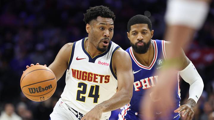 Jan 5, 2026; Philadelphia, Pennsylvania, USA; Denver Nuggets guard Jalen Pickett (24) drives past Philadelphia 76ers forward Paul George (8) during the fourth quarter at Xfinity Mobile Arena. Mandatory Credit: Bill Streicher-Imagn Images