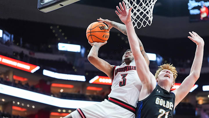 Louisville Cardinals guard Koren Johnson (3) gets two plus the foul against Spalding University's Levi Langley (21) in the second half in the Cards' second exhibition game against Spalding University at the KFC Yum! Center in Louisville, Kentucky Monday, Oct. 28, 2024. Louisville Cardinals guard Koren Johnson (3) gets two plus the foul against Spalding University's Levi Langley (21) in the second half in the Cards' second exhibition game against Spalding University at the KFC Yum! Center in Louisville, Kentucky Monday, Oct. 28, 2024.
