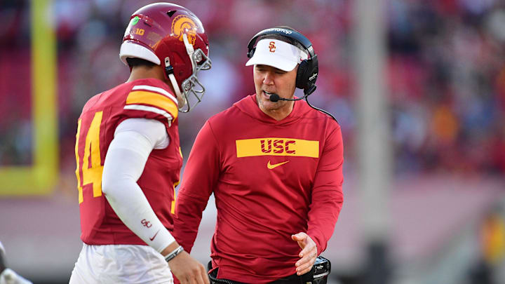 Nov 16, 2024; Los Angeles, California, USA; Southern California Trojans head coach Lincoln Riley greets quarterback Jayden Maiava (14) after scoring a touchdown against the Nebraska Cornhuskers during the second half at the Los Angeles Memorial Coliseum. 