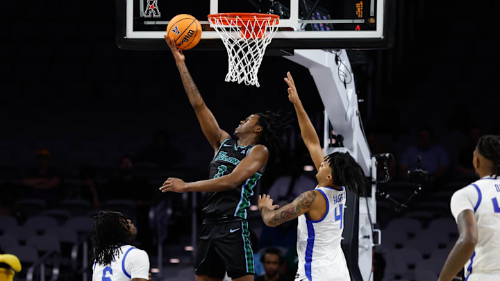 Mar 15, 2025; Fort Worth, TX, USA;  Tulane Green Wave guard Kam Williams (3) scores a layup against Memphis Tigers guard PJ Haggerty (4) during the second half at Dickies Arena. Mandatory Credit: Chris Jones-Imagn Images