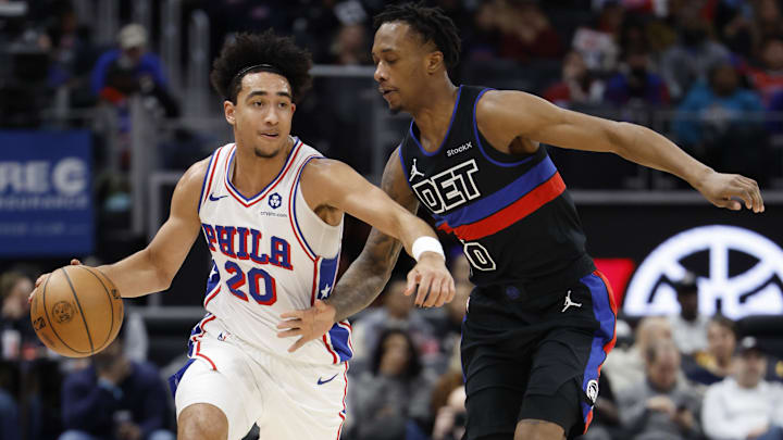 Nov 30, 2024; Detroit, Michigan, USA;  Philadelphia 76ers guard Jared McCain (20) dribbles on Detroit Pistons forward Ronald Holland II (00) in the first half at Little Caesars Arena. Mandatory Credit: Rick Osentoski-Imagn Images