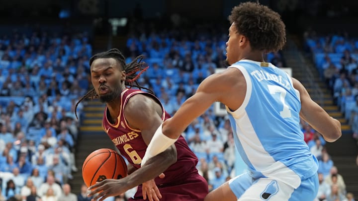 Dec 30, 2025; Chapel Hill, North Carolina, USA; Florida State Seminoles guard Robert McCray V (6) with the ball as North Carolina Tar Heels guard Seth Trimble (7) defends in the first half at Dean E. Smith Center. Mandatory Credit: Bob Donnan-Imagn Images