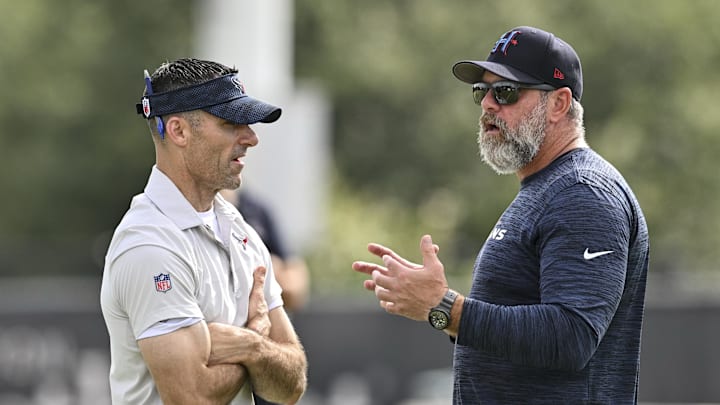 Jun 10, 2025; Houston, TX, USA; Houston Texans executive vice president and general manager Nick Caserio, left, speaks with defensive coordinator Matt Burke, right, during an NFL football minicamp at NRG Stadium. Mandatory Credit: Maria Lysaker-Imagn Images 