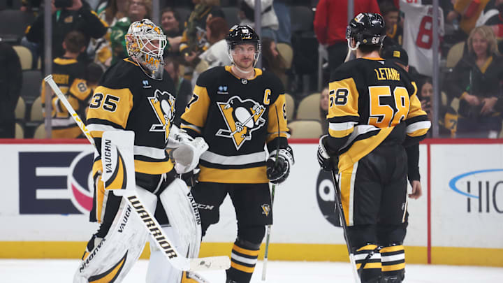 Mar 15, 2025; Pittsburgh, Pennsylvania, USA;  Pittsburgh Penguins goaltender Tristan Jarry (35) and center Sidney Crosby (87) and defenseman Kris Letang (58) celebrate after defeating the New Jersey Devils at PPG Paints Arena. Mandatory Credit: Charles LeClaire-Imagn Images