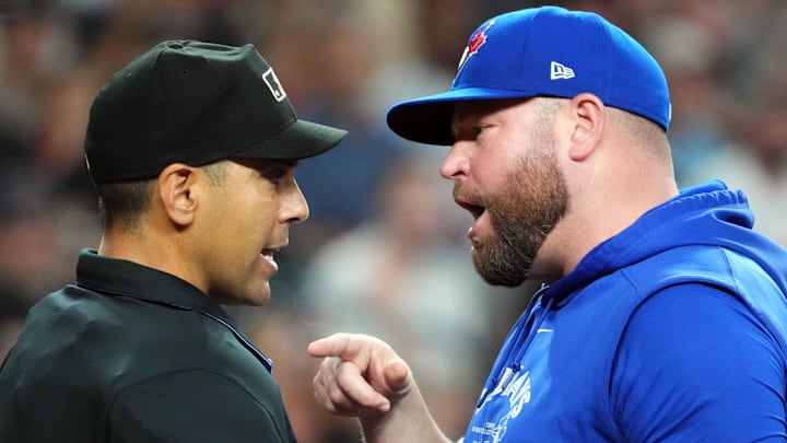 Jul 14, 2024; Phoenix, Arizona, USA; Toronto Blue Jays manager John Schneider (14) argues with home plate umpire Gabe Morales (47) after being ejected during the seventh inning of the game against the Arizona Diamondbacks at Chase Field. Mandatory Credit: Joe Camporeale-Imagn Images