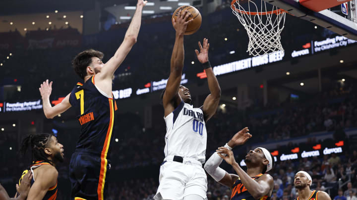 Apr 14, 2024; Oklahoma City, Oklahoma, USA; Dallas Mavericks guard Brandon Williams (00) shoots between Oklahoma City Thunder forward Chet Holmgren (7) and guard Shai Gilgeous-Alexander (2) during the second quarter at Paycom Center. Mandatory Credit: Alonzo Adams-USA TODAY Sports Apr 14, 2024; Oklahoma City, Oklahoma, USA; Dallas Mavericks guard Brandon Williams (00) shoots between Oklahoma City Thunder forward Chet Holmgren (7) and guard Shai Gilgeous-Alexander (2) during the second quarter at Paycom Center. Mandatory Credit: Alonzo Adams-USA TODAY Sports