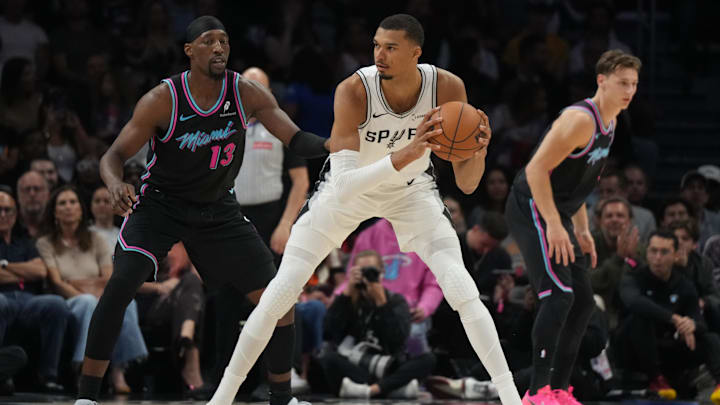 Mar 23, 2026; Miami, Florida, USA;  Miami Heat center Bam Adebayo (13) defends San Antonio Spurs forward Victor Wembanyama (1) during the first half at Kaseya Center. Mandatory Credit: Jim Rassol-Imagn Images
