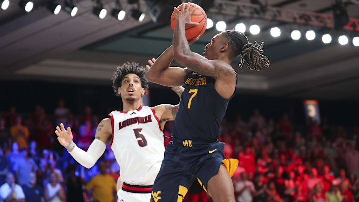 Nov 28, 2024; Paradise Island, Bahamas, BHS;  West Virginia Mountaineers guard Javon Small (7) shoots over Louisville Cardinals guard Terrence Edwards Jr. (5) during the second half at Imperial Arena at the Atlantis resort.  Mandatory Credit: Kevin Jairaj-Imagn Images