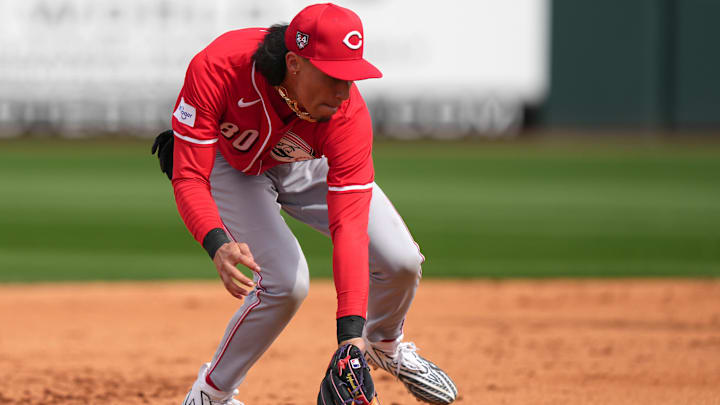 Feb. 24, 2024; Goodyear, Arizona, USA; Cincinnati Reds shortstop Edwin Arroyo fields a ground ball in the fifth inning during a MLB spring training baseball game against the Cleveland Guardians at Goodyear Ballpark. Mandatory Credit: Kareem Elgazzar-Imagn Images Feb. 24, 2024; Goodyear, Arizona, USA; Cincinnati Reds shortstop Edwin Arroyo fields a ground ball in the fifth inning during a MLB spring training baseball game against the Cleveland Guardians at Goodyear Ballpark. Mandatory Credit: Kareem Elgazzar-Imagn Images