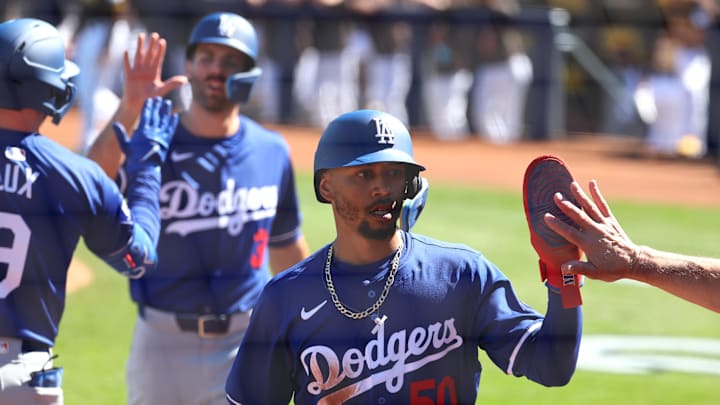 Feb 22, 2024; Peoria, Arizona, USA; Los Angeles Dodgers second baseman Mookie Betts celebrates with