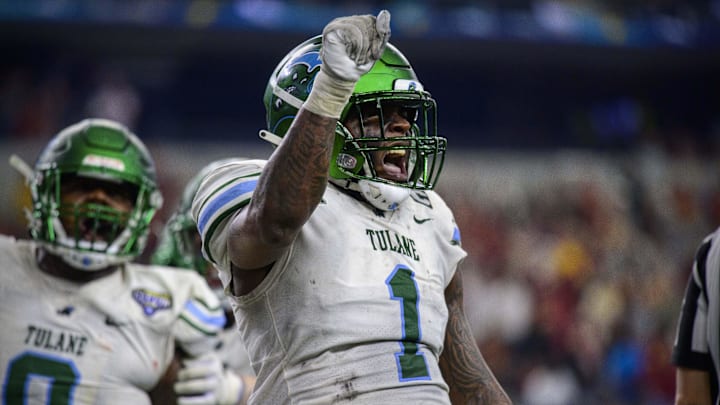 Jan 2, 2023; Arlington, Texas, USA; Tulane Green Wave defensive lineman Patrick Jenkins (0) and linebacker Nick Anderson (1) celebrates after they tackle USC Trojans running back Austin Jones (not pictured) for a safety during the second half in the 2023 Cotton Bowl at AT&T Stadium. Mandatory Credit: Jerome Miron-Imagn Images