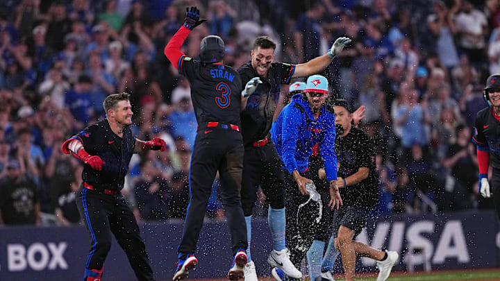 Jul 4, 2025; Toronto, Ontario, CAN; Toronto Blue Jays third baseman Ernie Clement (22) celebrates the win with outfielder Myles Straw (3) against the Los Angeles Angels during  the tenth inning at Rogers Centre.