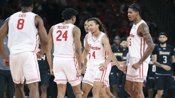 Nov 8, 2025; Houston, Texas, USA; Houston Cougars guard Kingston Flemings (4) celebrates with teammates after scoring during the second half against the Towson Tigers at Fertitta Center. Mandatory Credit: Troy Taormina-Imagn Images
