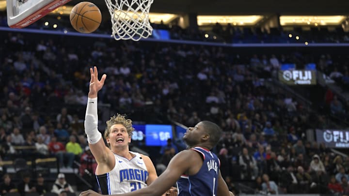 Nov 20, 2024; Inglewood, California, USA;  Orlando Magic center Moritz Wagner (21) drives past Los Angeles Clippers center Mo Bamba (4) in the second half at Intuit Dome. Mandatory Credit: Jayne Kamin-Oncea-Imagn Images