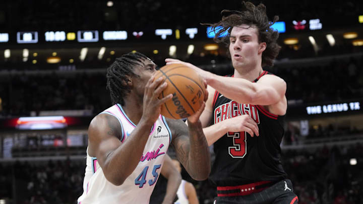 Apr 9, 2025; Chicago, Illinois, USA; Chicago Bulls guard Josh Giddey (3) defends Miami Heat guard Davion Mitchell (45) during the second half at United Center. Mandatory Credit: David Banks-Imagn Images