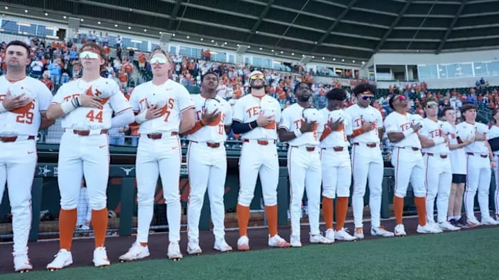 The Texas Longhorns line up for the national anthem prior to the first pitch.