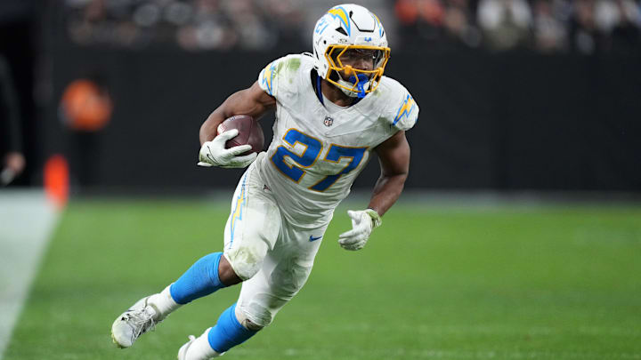 Jan 5, 2025; Paradise, Nevada, USA; Los Angeles Chargers running back J.K. Dobbins (27) carries the ball against the Las Vegas Raiders in the second half at Allegiant Stadium. 