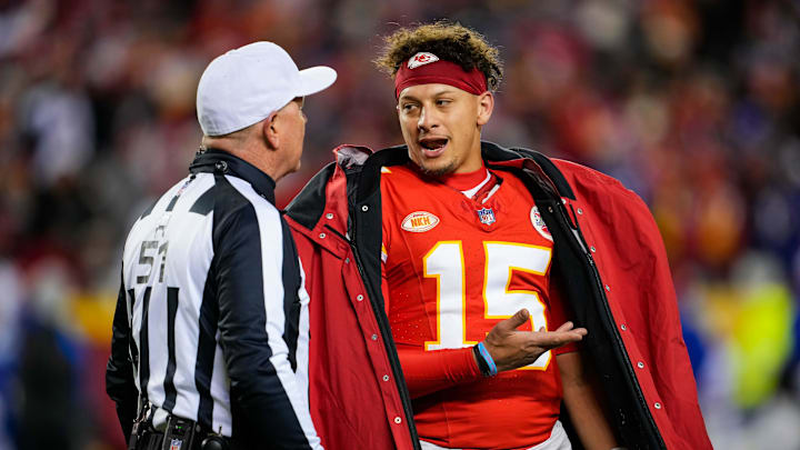 Kansas City Chiefs quarterback Patrick Mahomes (15) talks with referee Carl Cheffers (51) after penalty during the second half against the Buffalo Bills at GEHA Field at Arrowhead Stadium. 