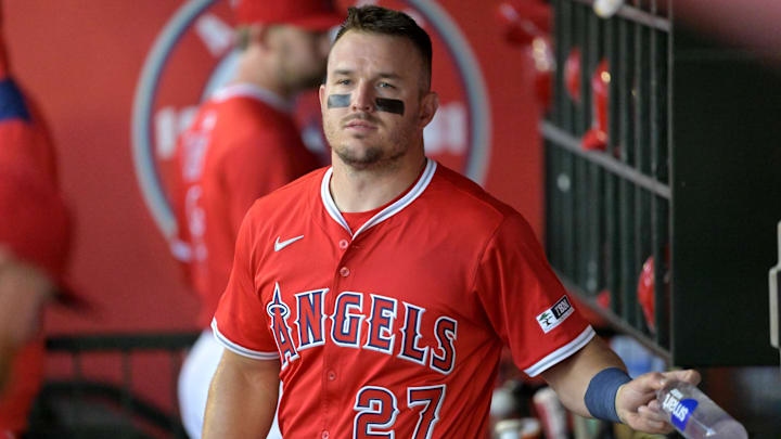 Mar 24, 2025; Anaheim, California, USA;  Los Angeles Angels center fielder Mike Trout (27) looks on from the dugout against the Los Angeles Dodgers at Angel Stadium. 