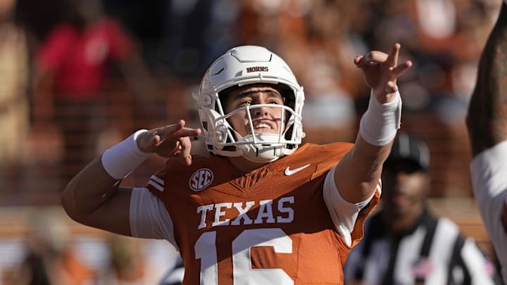 Texas Longhorns quarterback Arch Manning (16) reacts after throwing a touchdown pass in the first half against the Arkansas Razorbacks at Darrell K Royal-Texas Memorial Stadium.