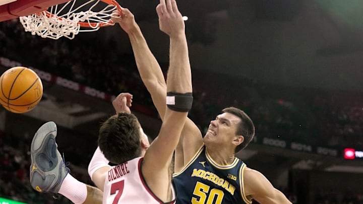 Michigan center Vladislav Goldin dunks on Wisconsin forward Carter Gilmore during the first half Tuesday night at the Kohl Center.Mark Hoffman/Milwaukee Journal Sentinel