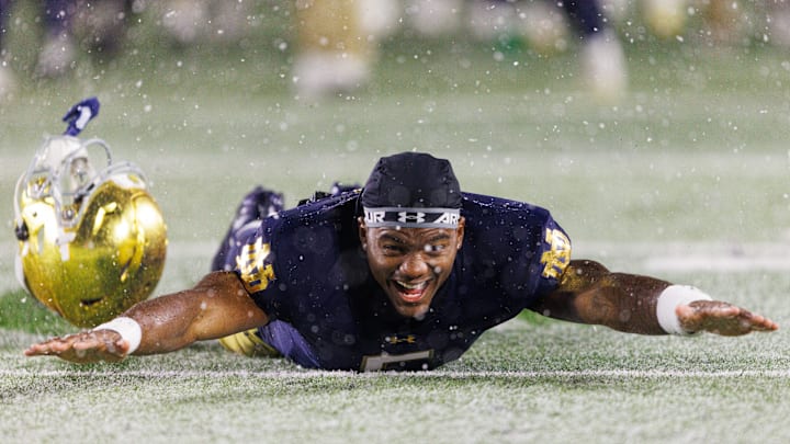 Notre Dame wide receiver Cam Williams slides in the snow after winning a NCAA football game 49-10 against Navy at Notre Dame Stadium on Saturday, Nov. 8, 2025, in South Bend.