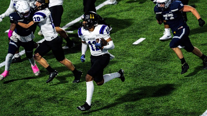 Waukee's Malachi Curvey (11) runs the ball during the first game at Mediacom Field on Thursday,