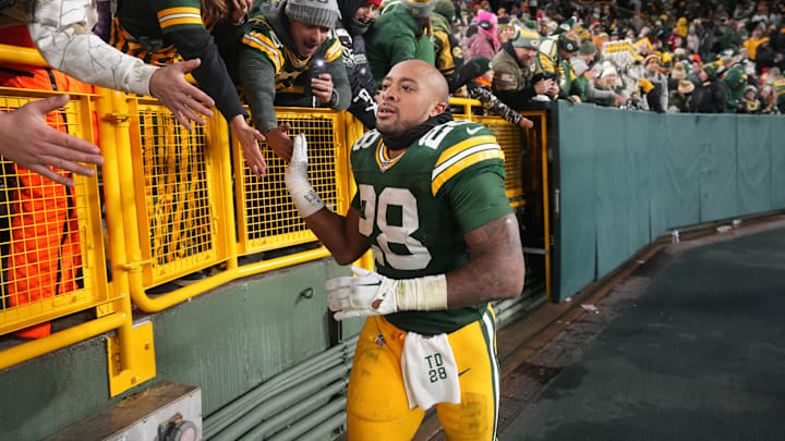 Dec 3, 2023; Green Bay, Wisconsin, USA; Green Bay Packers running back AJ Dillon (28) makes a victory lap after their game against the Kansas City Chiefs at Lambeau Field. Mandatory Credit: Mark Hoffman-Imagn Images