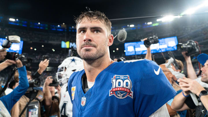 Sep 26, 2024; East Rutherford, NJ, US; New York Giants quarterback Daniel Jones (8) embraces Dallas Cowboys quarterback Dak Prescott (4) following the end of the game at MetLife Stadium.  