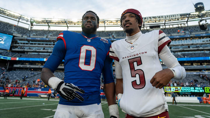 New York Giants linebacker Brian Burns (0) poses with Washington Commanders quarterback Jayden Daniels (5) after the game between the New York Giants and the Washington Commanders at MetLife Stadium in East Rutherford on Sunday, Nov. 3, 2024.