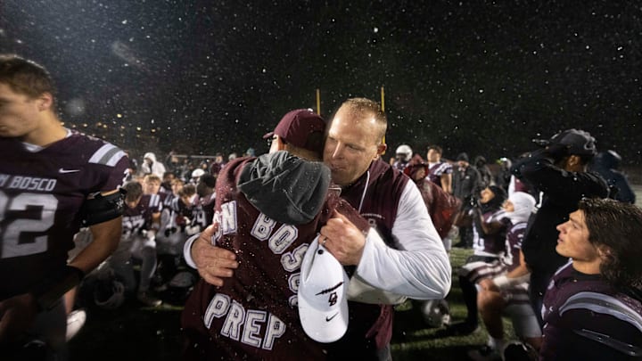 Nov 22, 2024; Ramsey, NJ, USA; St. Augustine Prep at Don Bosco Prep in the NJSIAA Non-Public A football semifinals. Don Bosco head coach Dan Sabella and his team celebrate defeating St. Augustine.