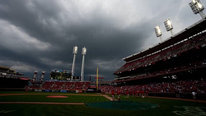 Grounds crew puts a tarp on home plate as the game between Cincinnati Reds and Chicago Cubs is delayed by rain at Great American Ball Park in Cincinnati on Sept. 21, 2025.