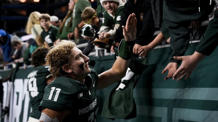 Nov 29, 2025; Detroit, Michigan, USA; Michigan State quarterback Alessio Milivojevic (11) shakes hands with fans after defeating Maryland at Ford Field. Mandatory Credit: Brendan Mullin-Imagn Images