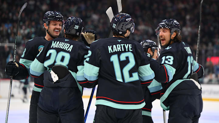 Nov 16, 2024; Seattle, Washington, USA; The Seattle Kraken celebrate after a goal scored by center Yanni Gourde (37) (not pictured) during the first period against the New York Islanders at Climate Pledge Arena. Mandatory Credit: Steven Bisig-Imagn Images