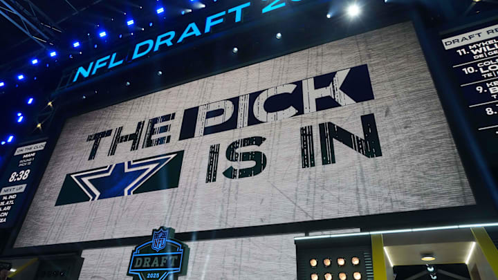 The Dallas Cowboys logo is projected on the video board during the NFL Draft at Lambeau Field. 
