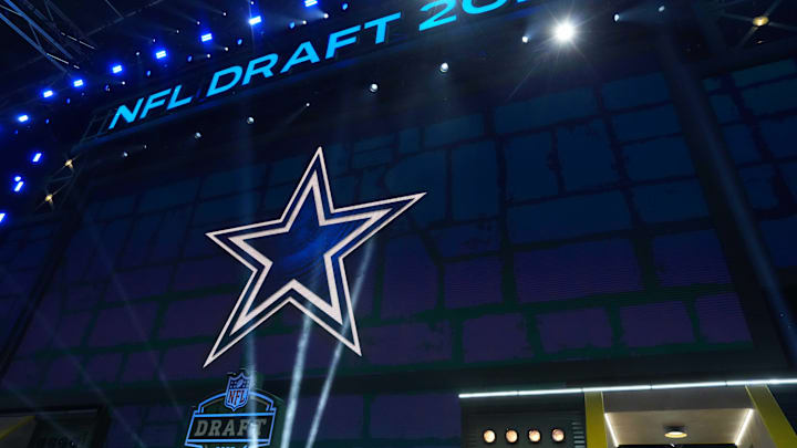 The Dallas Cowboys logo is projected on the video board during the NFL Draft at Lambeau Field. The Dallas Cowboys logo is projected on the video board during the NFL Draft at Lambeau Field.