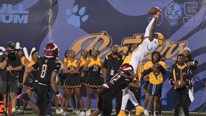 Miami Northwestern's Calvin Russell Jr. leaps for a tough catch attempt during the first half of the Class 3A state championship on Dec. 14, 2024.