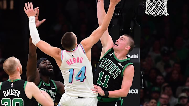 Apr 2, 2025; Boston, Massachusetts, USA; Miami Heat guard Tyler Herro (14) and Boston Celtics guard Payton Pritchard (11) battle for a loose ball during the second half at TD Garden. Mandatory Credit: Bob DeChiara-Imagn Images