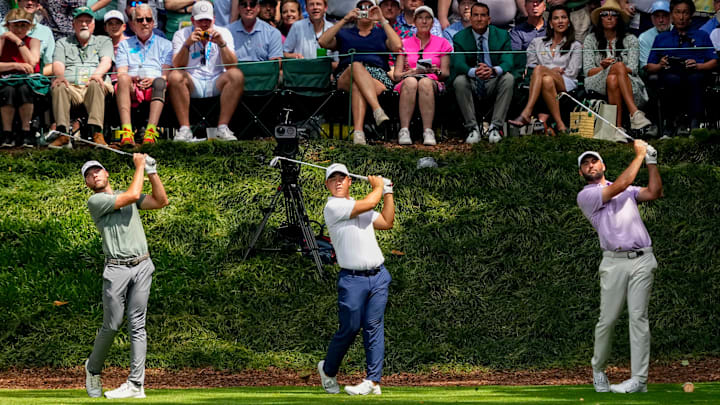 Sam Burns, Tom Kim, and Scottie Scheffler tee off on No. 9 during the 2024 Masters Par 3 Contest at Augusta National Golf Club