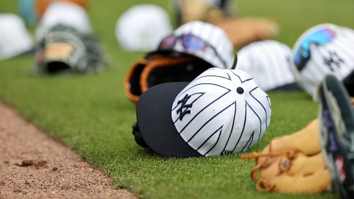 Feb 20, 2025; Tampa, FL, USA; A general view of New York Yankees players hats and gloves on the field during workouts at George M. Steinbrenner Field. Mandatory Credit: Kim Klement Neitzel-Imagn Images